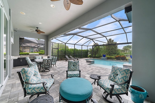 view of patio with ceiling fan, area for grilling, a lanai, and pool water feature