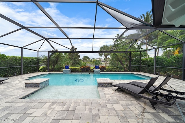 view of pool with a lanai, a patio, and pool water feature