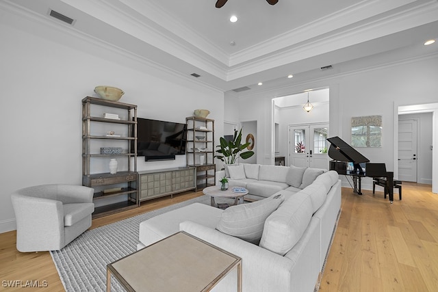 living room with ceiling fan, light hardwood / wood-style floors, french doors, and ornamental molding