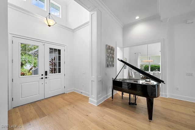 5154 Andros Dr, Naples, FL 34113 - entrance foyer with a high ceiling, light wood finished floors, french doors, baseboards, and ornamental molding