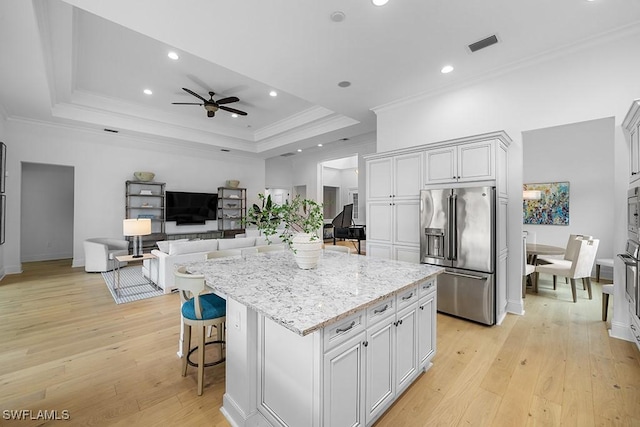 5154 Andros Dr, Naples, FL 34113 - kitchen featuring light stone countertops, light wood-style flooring, high end refrigerator, a ceiling fan, and visible vents