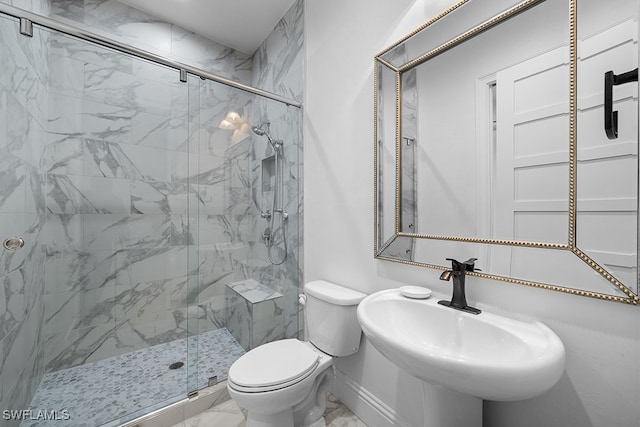 bathroom featuring sink, toilet, and a shower with door