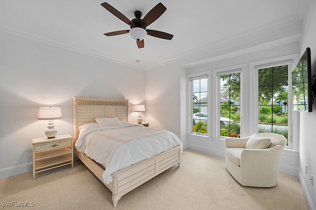 carpeted bedroom featuring ornamental molding and ceiling fan