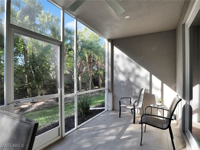 sunroom / solarium with plenty of natural light and ceiling fan