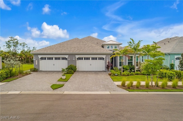 view of front of house featuring a front lawn and a garage