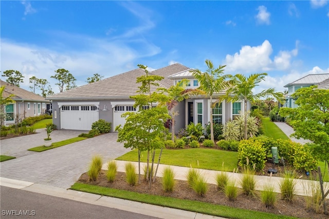 view of front of house featuring a front yard and a garage