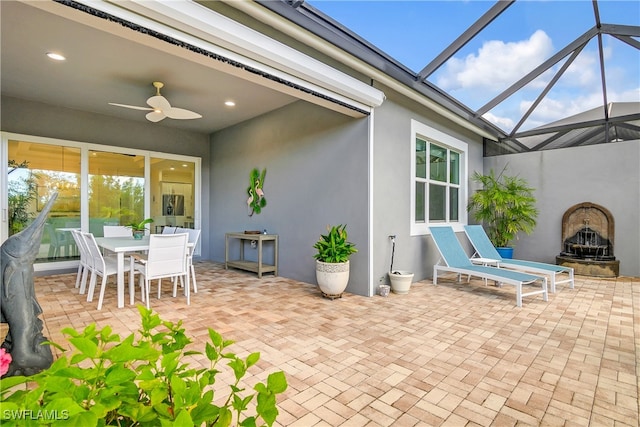 view of patio / terrace featuring a lanai and ceiling fan