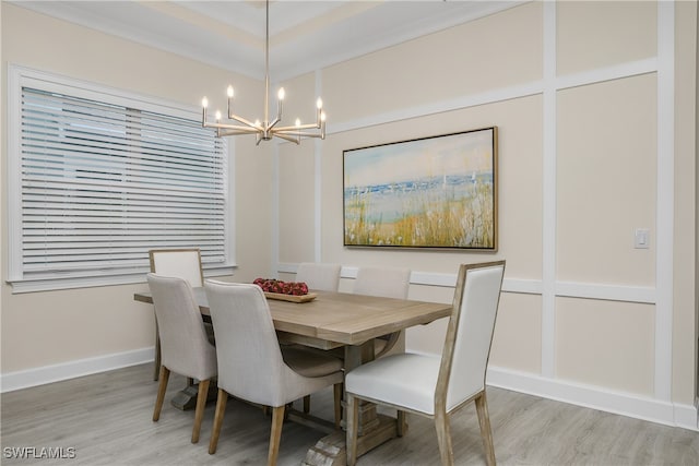 dining area featuring a notable chandelier and light wood-type flooring