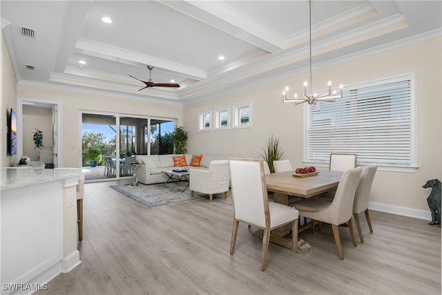 dining area featuring ceiling fan with notable chandelier, light hardwood / wood-style flooring, plenty of natural light, and crown molding