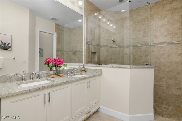 bathroom with vanity, tile patterned floors, and tiled shower