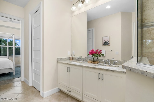 bathroom with vanity, a tile shower, and tile patterned floors