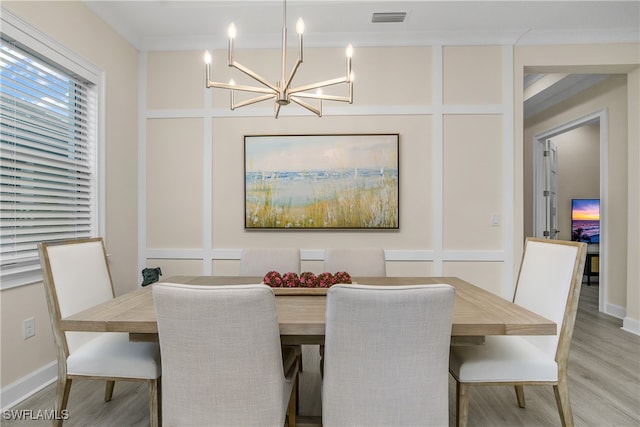 dining room with hardwood / wood-style flooring and a notable chandelier