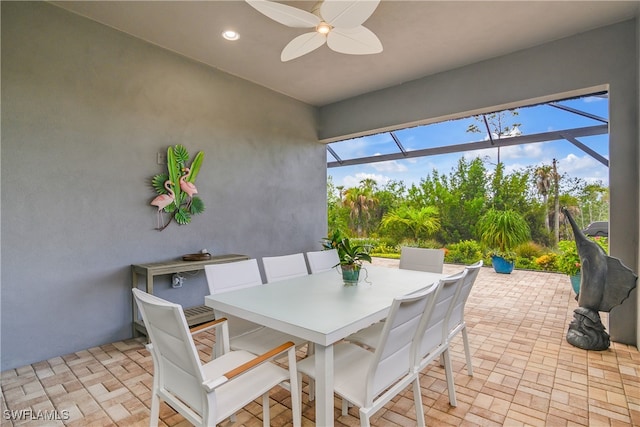 sunroom featuring ceiling fan