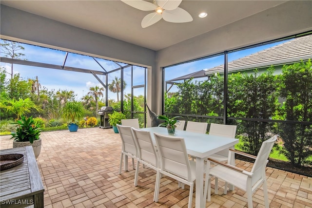 sunroom featuring ceiling fan