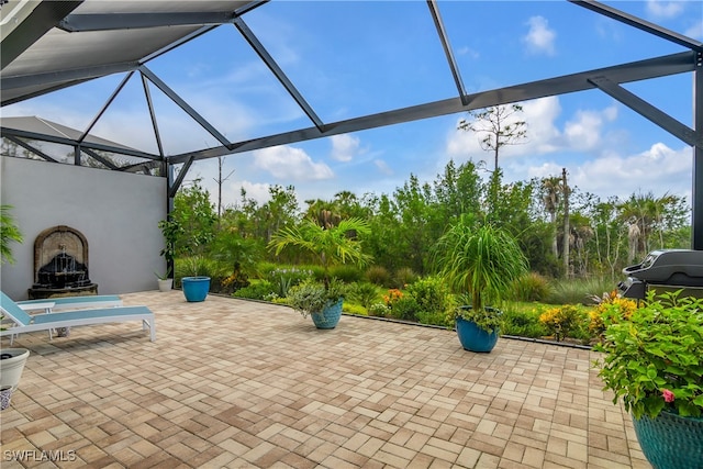 view of patio with exterior fireplace and a lanai