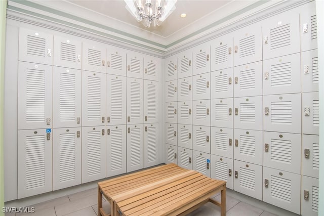 walk in closet featuring light tile patterned floors and a chandelier