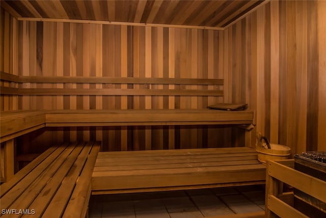 view of sauna / steam room featuring wooden walls, tile patterned flooring, and wooden ceiling