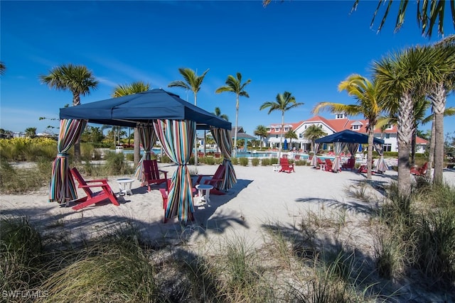 view of playground featuring a water view and a gazebo