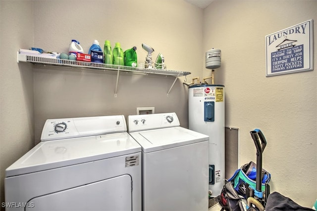 laundry area featuring electric water heater and independent washer and dryer