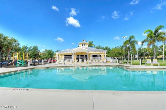 view of pool with a playground and a patio area