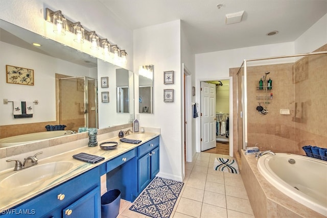 bathroom with tile patterned floors, vanity, and separate shower and tub