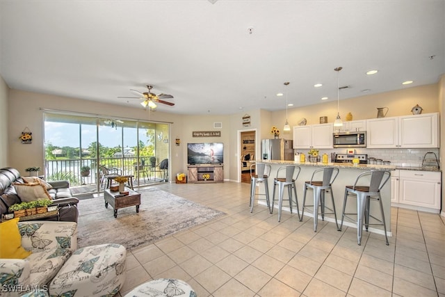 living room featuring ceiling fan and light tile patterned flooring