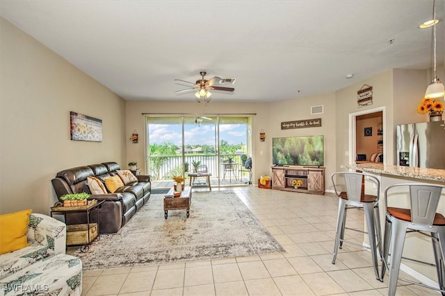 tiled living room featuring ceiling fan