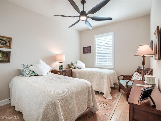 bedroom with hardwood / wood-style flooring and ceiling fan