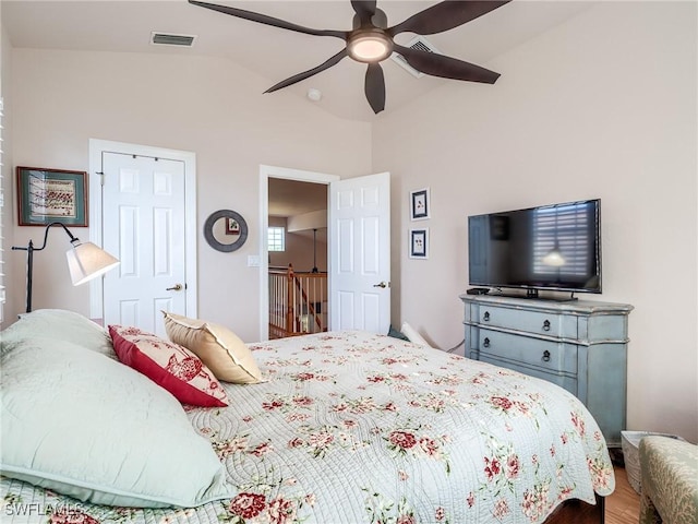 bedroom with hardwood / wood-style floors, vaulted ceiling, and ceiling fan