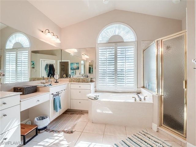 bathroom with plenty of natural light, tile patterned floors, plus walk in shower, and vaulted ceiling