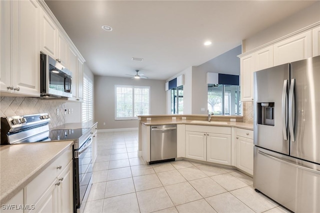 kitchen with white cabinetry, sink, tasteful backsplash, and stainless steel appliances