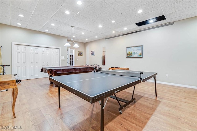 rec room with a drop ceiling, light hardwood / wood-style flooring, and billiards