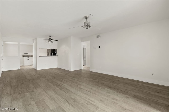 unfurnished living room with light wood-type flooring and ceiling fan