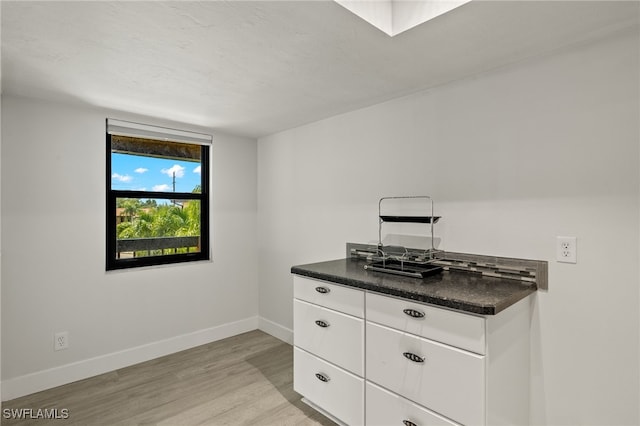 kitchen featuring white cabinets and light wood-type flooring