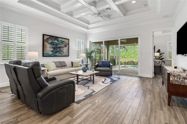 living room featuring light hardwood / wood-style floors, beam ceiling, coffered ceiling, ornamental molding, and ceiling fan