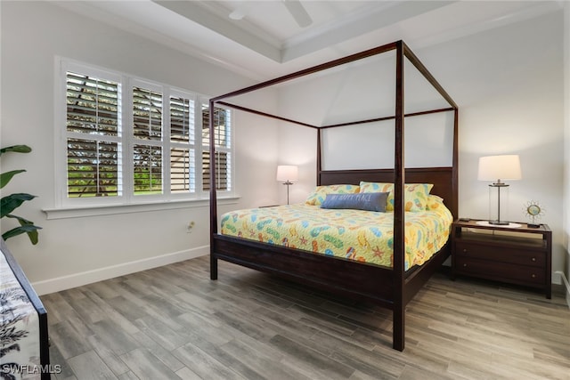 bedroom with ceiling fan, crown molding, and wood-type flooring