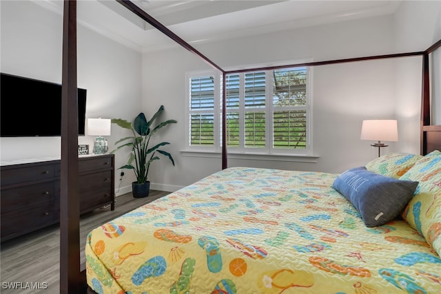 bedroom with ornamental molding and wood-type flooring