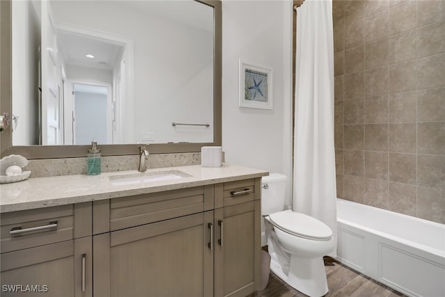 full bathroom with wood-type flooring, vanity, toilet, and shower / bath combo