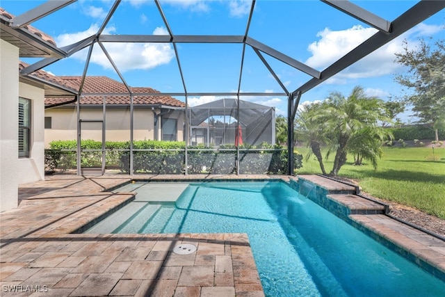 view of swimming pool with pool water feature, glass enclosure, a patio area, and a lawn