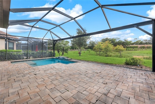 view of swimming pool featuring pool water feature, glass enclosure, a patio, and a lawn