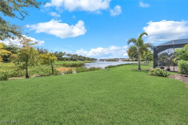 view of yard featuring a water view and a lanai