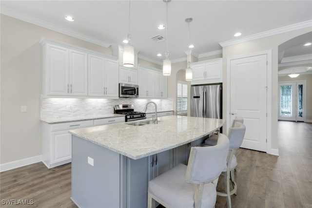 kitchen with white cabinets, stainless steel appliances, and plenty of natural light