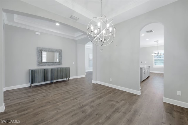 empty room with an inviting chandelier, crown molding, and dark hardwood / wood-style floors