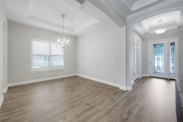 foyer entrance featuring a tray ceiling, a chandelier, and hardwood / wood-style flooring