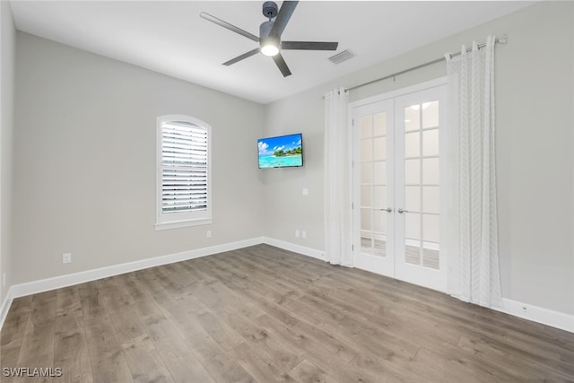 spare room featuring ceiling fan, light hardwood / wood-style flooring, and french doors