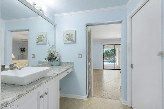 bathroom featuring tile patterned flooring, vanity, and crown molding