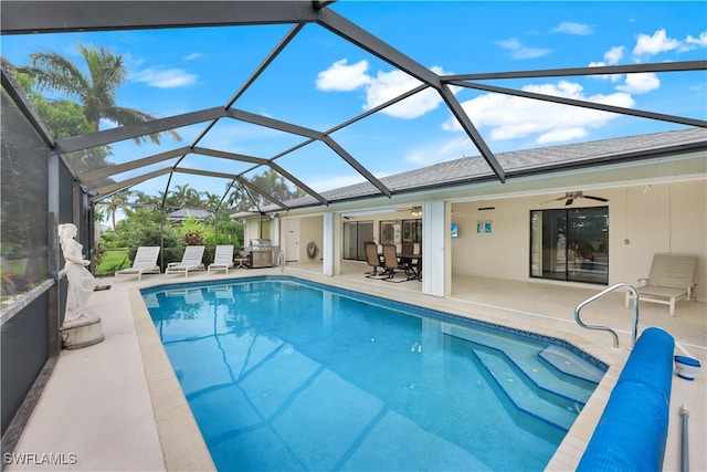 view of swimming pool featuring a patio, a lanai, and ceiling fan