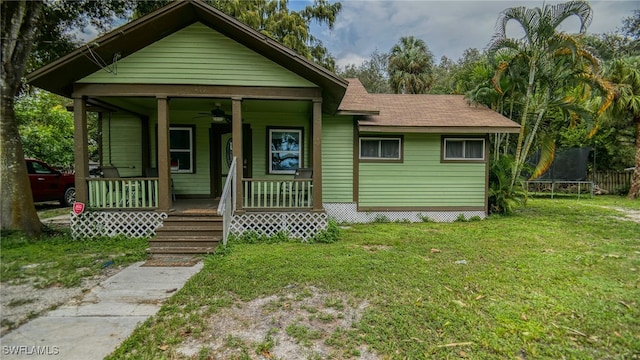 bungalow-style home with covered porch, a front yard, and ceiling fan