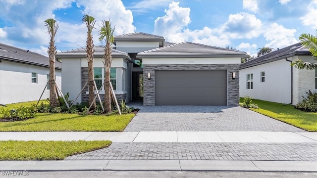 view of front of home with a front lawn and a garage