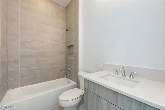 full bathroom with vanity, tiled shower / bath combo, and toilet